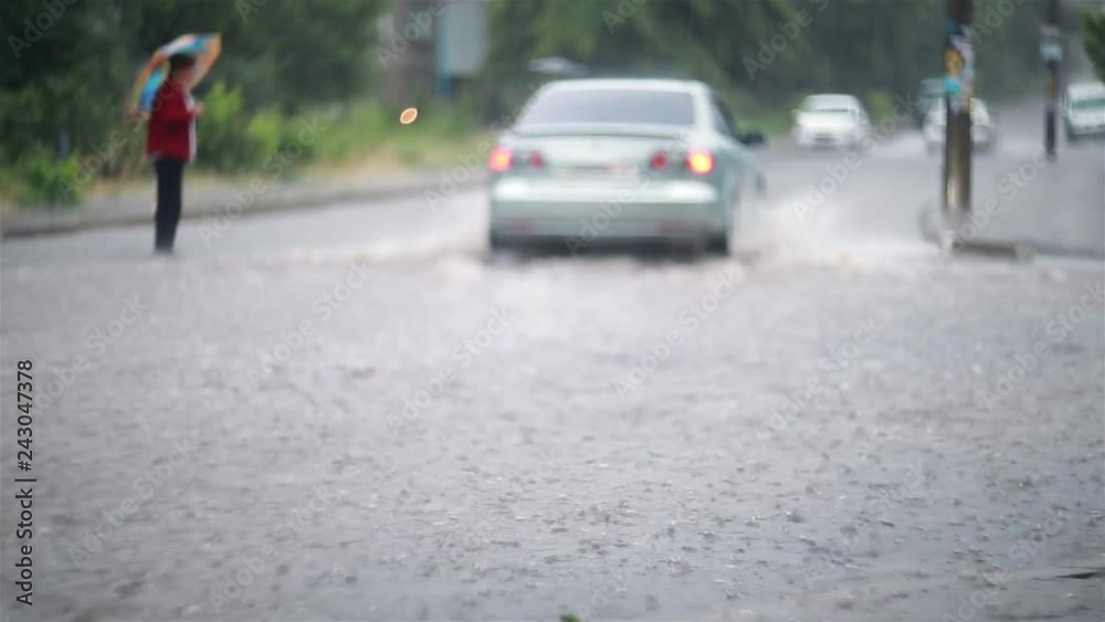 Car traffic, people pedestrians on the flooded city streets during heavy rain, heavy rainfall. Disaster flood, deluge Car traffic, people pedestrians on the flooded city streets during heavy rain, heavy rainfall. Disaster flood, deluge