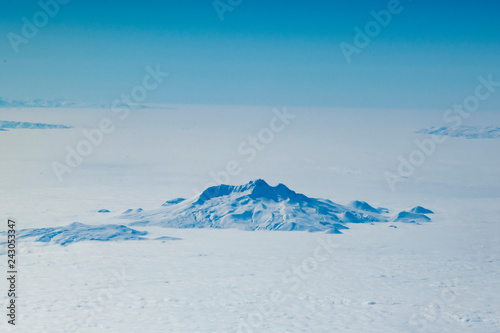  Aerial view of snowcapped mountains against cloudy sky
