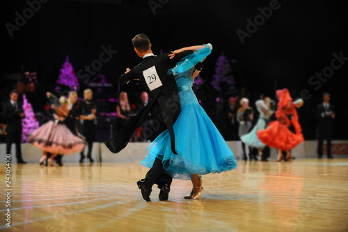 young couple athletes dancers competition in ballroom dancing photo