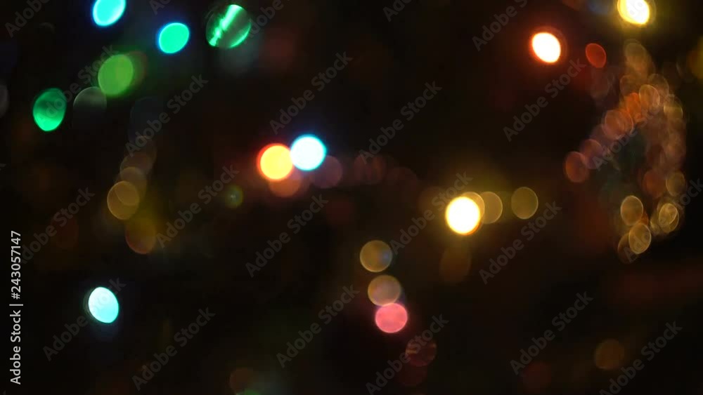 Glowing lights garland. Blurred image. Color blinking. Dark background. New year mood. Festive atmosphere. Glowing lights garland. Blurred image. Color blinking. Dark background. New year mood. Festive atmosphere.
