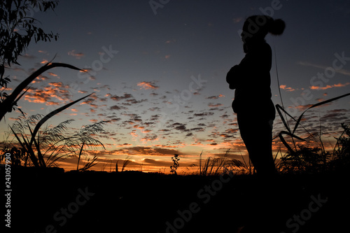 Silhouette woman at sunrise.