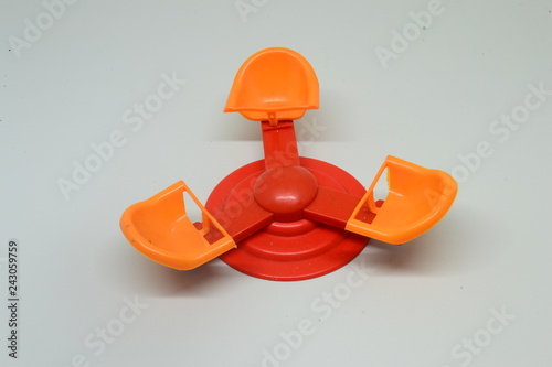 orange toy swing made of plastic