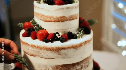 naked cake, white, three-tier, wedding, someone decorates a fruit cake