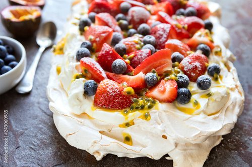 Pavlova Meringue Cake with Berries and Passionfruit Top View photo