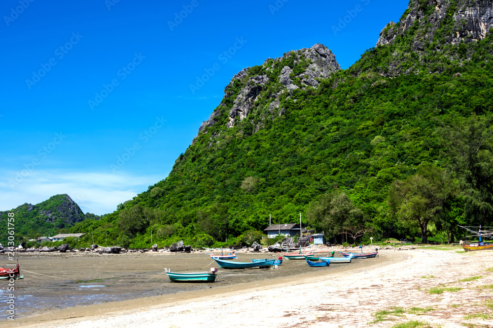 Fototapeta premium Fishing boat in the bay, mountain and the clear blue sky