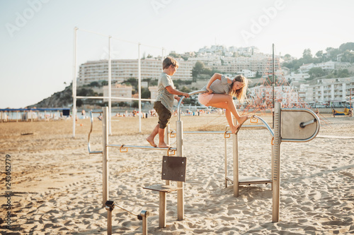 Two kids having fun on beach playground, summer vacation