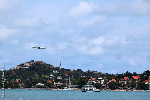 Airplane in the sky with white clouds and blue sky at samui island
