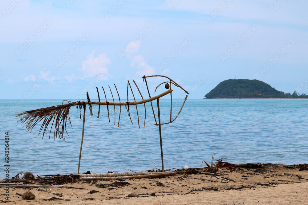 Art on the beach , fish skeleton from wood and waste