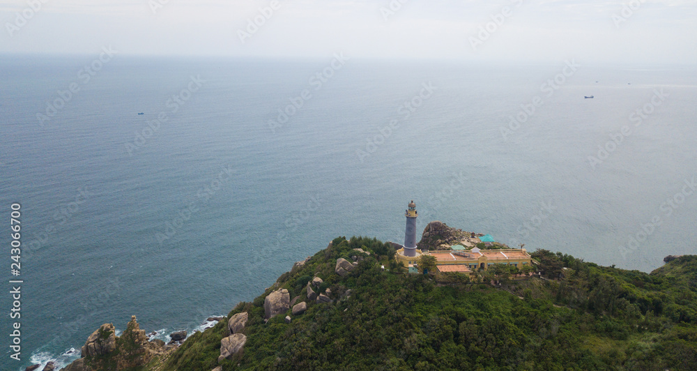 Aerial view of Dai Lanh beach and Mui Dien light house in a sunny day, MuiDien, Phu Yen province - The eastermost of Vietnam. Stock image top view of Mui Dien lighthouse on fractured rocky cliff 