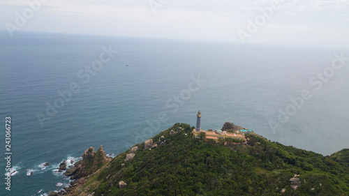 Aerial view of Dai Lanh beach and Mui Dien light house in a sunny day, MuiDien, Phu Yen province - The eastermost of Vietnam. Stock image top view of Mui Dien lighthouse on fractured rocky cliff 
