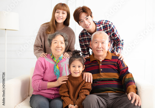 happy three generations asian family on sofa