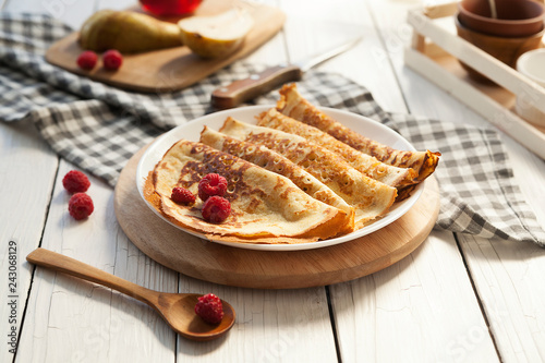 Pancakes Thin homemade pancakes with berries, traditional Russian cuisine. Homemade pancakes with berries