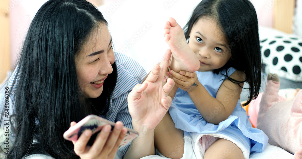 Mother and daughter playing toy in house