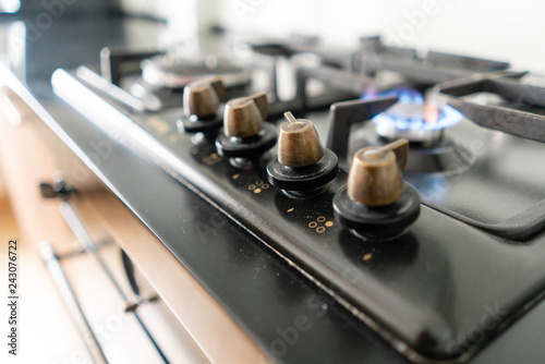 Closeup shot of blue fire from domestic kitchen hob. Gas cooker with burning flames propane gas.