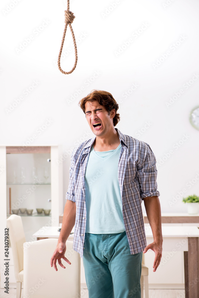 Fototapeta premium Young man preparing to commit suicide by hanging