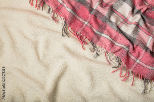 Winter time. A cozy warm pink blanket and a cup of coffee and croissants on the bed.