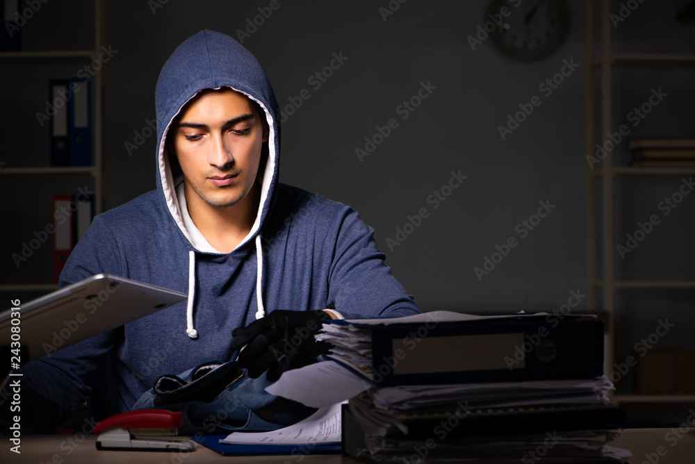 Thief trying to steal personal data in identity theft concept Thief trying to steal personal data in identity theft concept