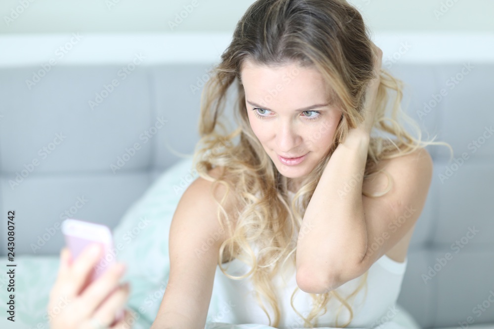 The young attractive girl is taking a selphie The young attractive girl is taking a selphie