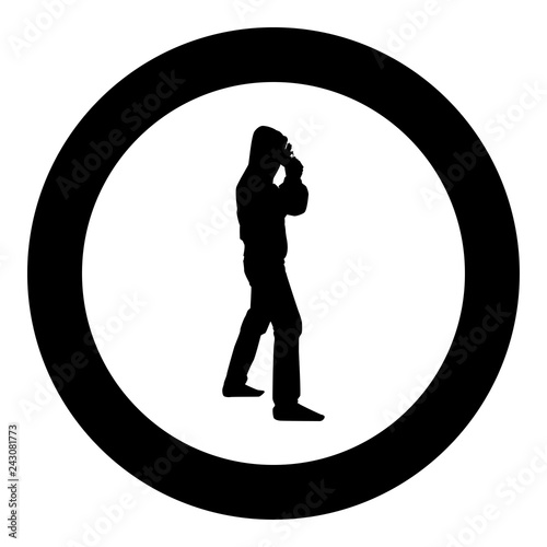Man in the hood with gun Concept danger short arm near head icon black color illustration in circle round