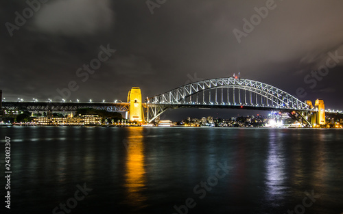 Night photography of Sydney Harbour Bridge in cloudy night.