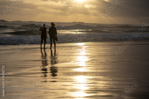 Couple on beach during sunset