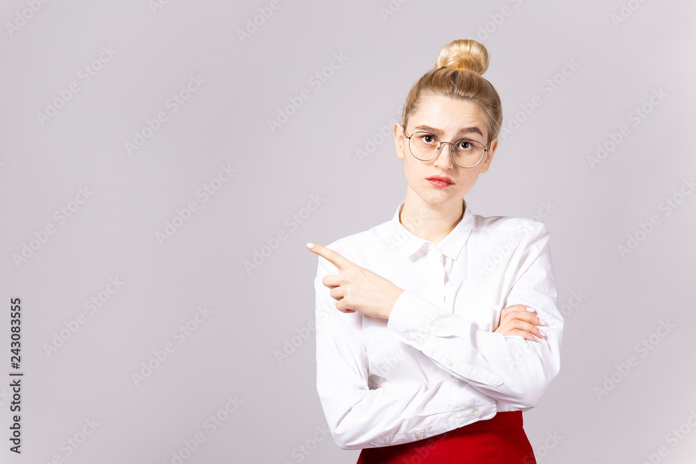 Studio shot of gorgeous young blonde business woman wearing round eyeglasses, white cotton blouse top & sexy tight red skirt. Gray isolated background, copy space, close up, portrait Studio shot of gorgeous young blonde business woman wearing round eyeglasses, white cotton blouse top & sexy tight red skirt. Gray isolated background, copy space, close up, portrait