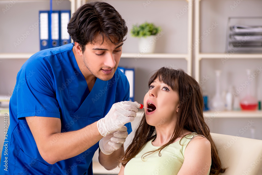 Doctor getting saliva test sample in clinic hospital Doctor getting saliva test sample in clinic hospital