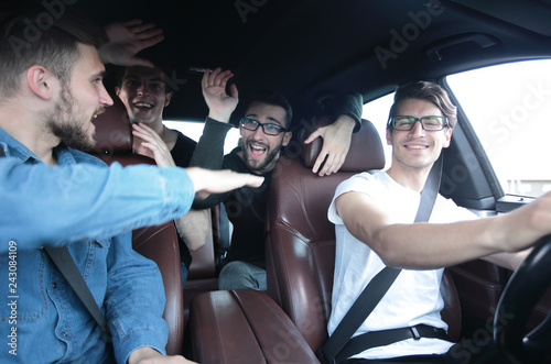 close up.happy friends talking in the car.