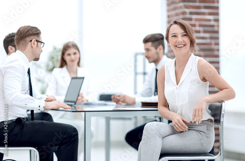 smiling employee and business team sitting at the Desk