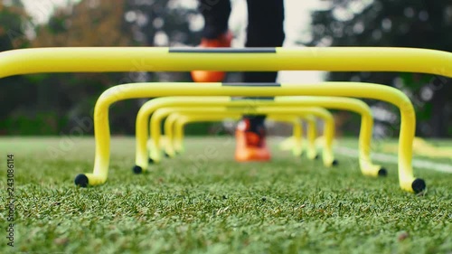 Soccer agility training equipment. Professional football player with training hurdles. 4k