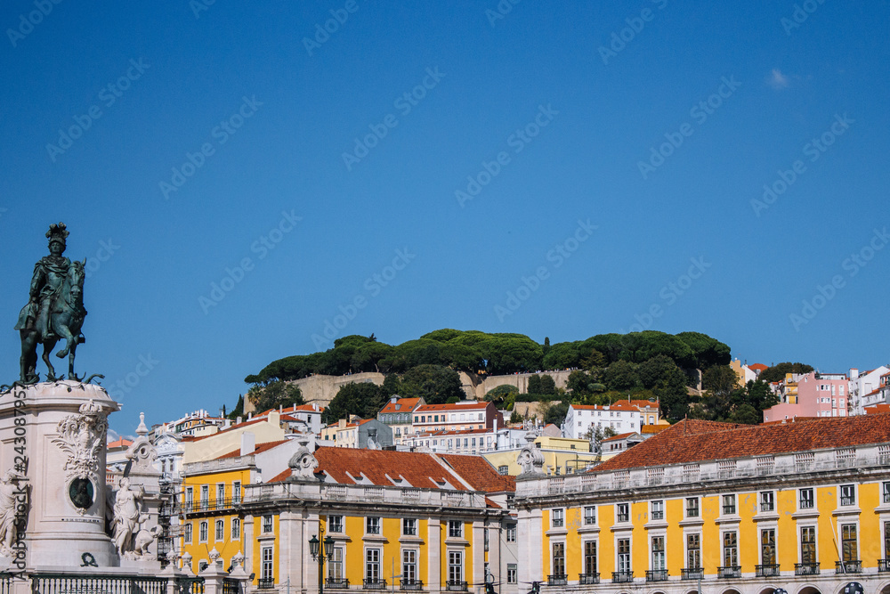 Panoramic view of Commerce Square, Portugal, Lisbon. Cityscape of historic Lisboa under clear blue sky. European buildings and architecture. Travel concept. Don Pedro monument on Commerce Square.