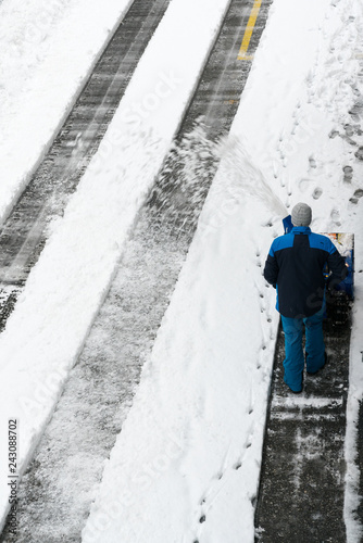 man with a snow blower clears snow from a road after a heavy snowfall © makasana photo