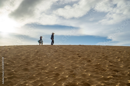 Woman leasing Plastic Boards at the Red Sand Dunes in Mui Ne