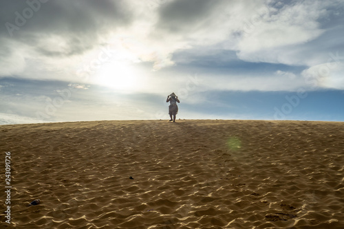 Woman on top of a Sand Dune in Mui Ne, Vietnam