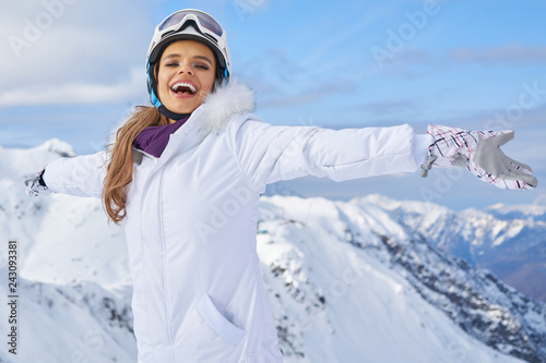 Young woman skier at winter ski resort in mountains, 