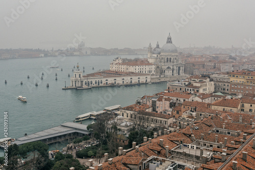 Morning in Venice. Top view on foggy lagoon and tile roofs