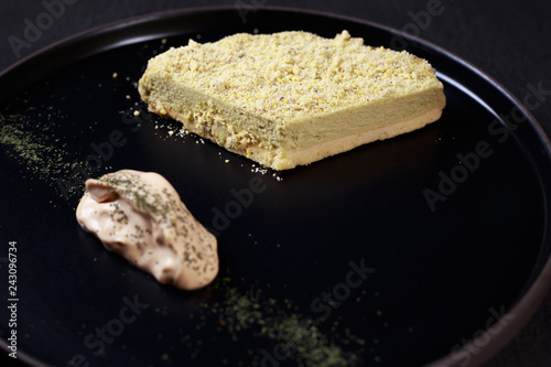confectionery, sweets, professional culinary. pistachio cheesecake and cream, delicious chefs's dessert