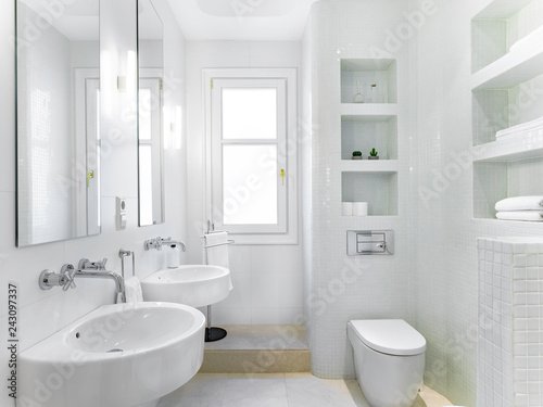 Clean bright bathroom interior with vintage steel faucet and white tiles. Original designed space with modern pieces