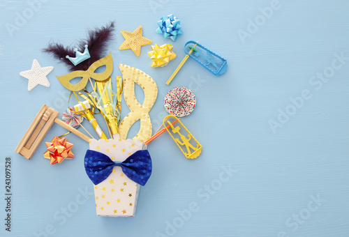 Purim celebration concept (jewish carnival holiday) over wooden blue background. photo