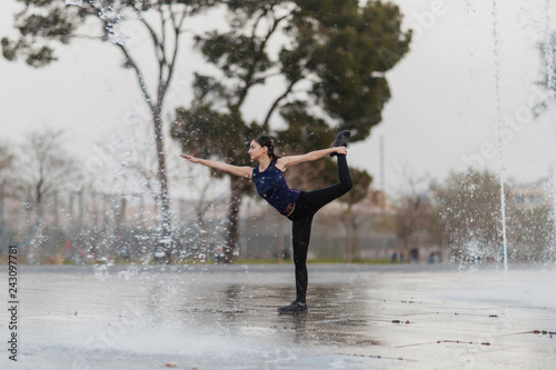 Young girl does yoga at the park