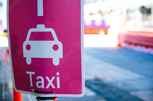 Photography Taxi pick-up point sign in pink color.