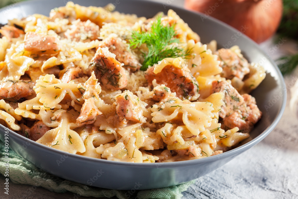 Creamy farfalle pasta with salmon, parmesan cheese and dill Creamy farfalle pasta with salmon, parmesan cheese and dill