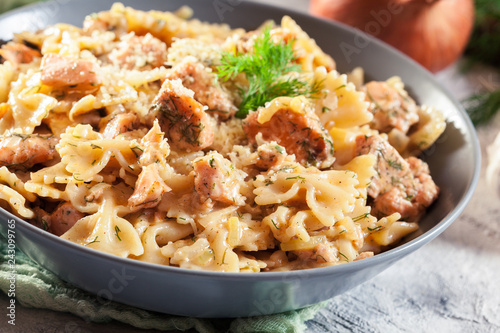 Creamy farfalle pasta with salmon, parmesan cheese and dill