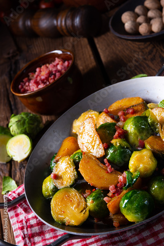 Brussels sprouts potato pan with bacon in rustic style