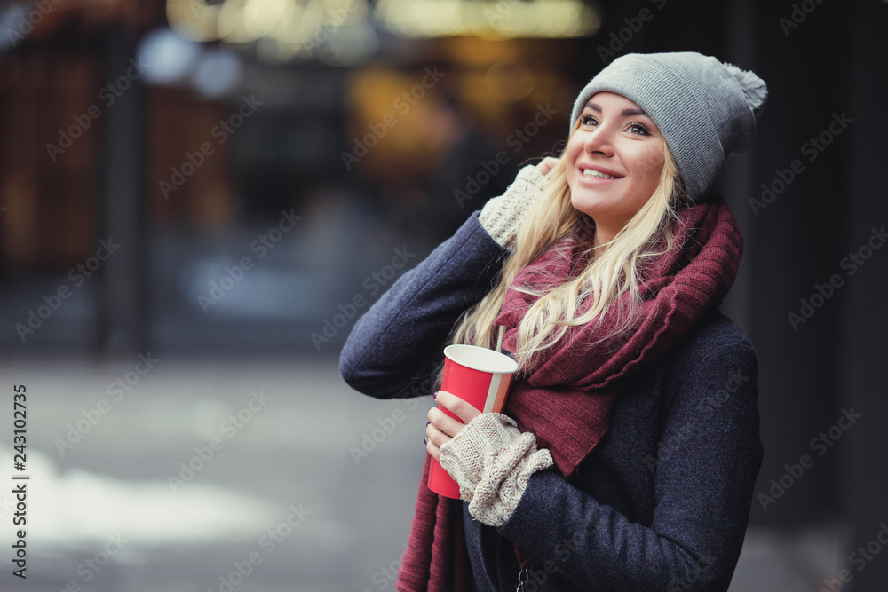 Close-up portrait of young blonde woman drinking coffe and enjoying the morning on the street. - Image Close-up portrait of young blonde woman drinking coffe and enjoying the morning on the street. - Image