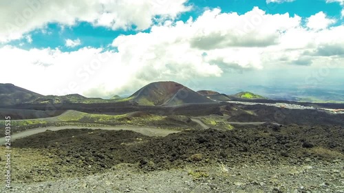 Picturesque volcanic landscape of Mount Etna, Etna national park, Sicily, Italy. View from mt.Calcarazzi o Corvo (2057m). Crater Silvestri Superiori (2001m) on the background. Time Lapse