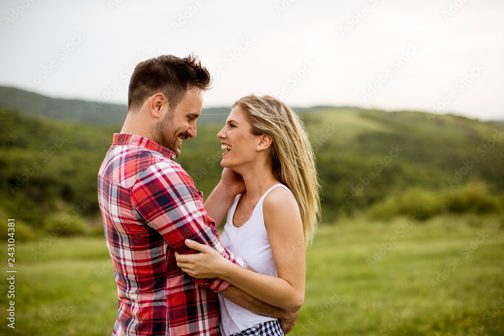 Loving embracing coulpe having fun in the spring nature Loving embracing coulpe having fun in the spring nature