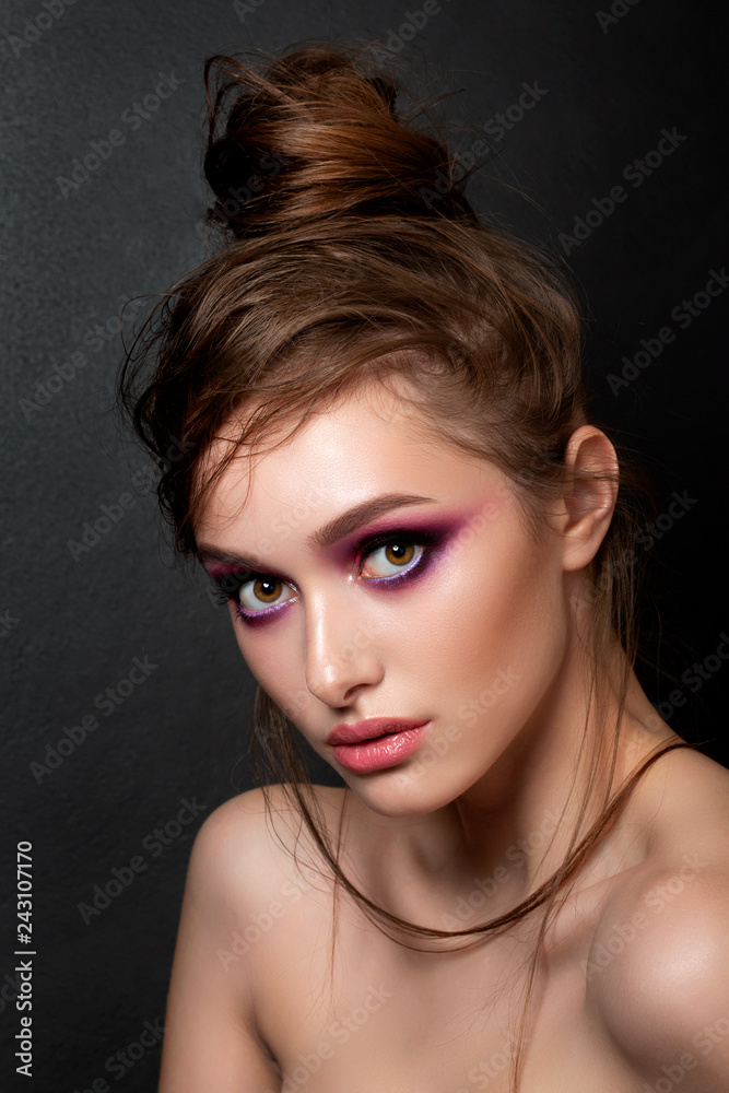 Closeup portrait of young beautiful woman with bright pink smokey eyes. Fashion makeup. Studio shot. Modern bright summer make up