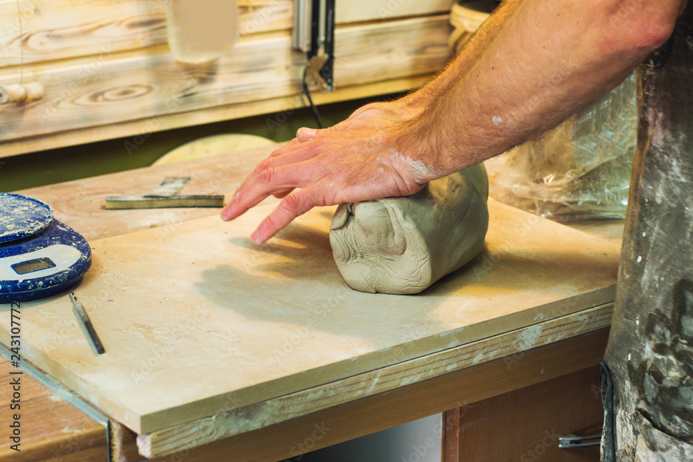 Artist potter in the workshop preparing material for sculpting ceramic vase. Hands closeup. Small artistic craftsmen business concept. Artist potter in the workshop preparing material for sculpting ceramic vase. Hands closeup. Small artistic craftsmen business concept.