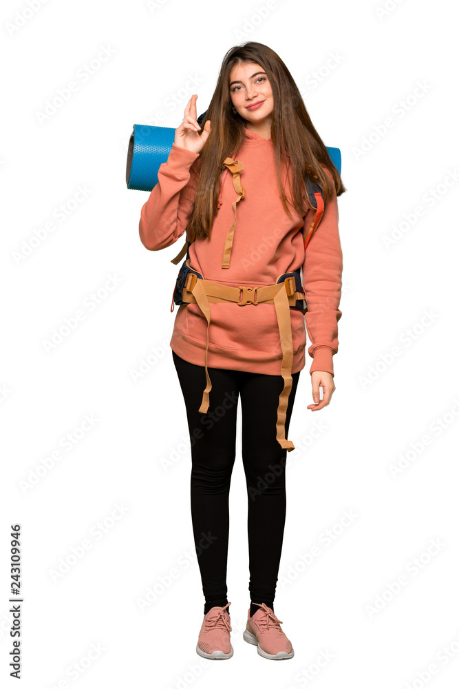 Naklejka premium Full-length shot of Hiker girl with fingers crossing and wishing the best on isolated white background